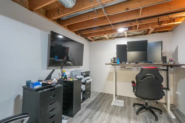 a front view of house with yard and trees in the background