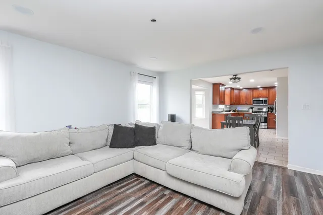 a kitchen with stainless steel appliances granite countertop a refrigerator and a stove top oven