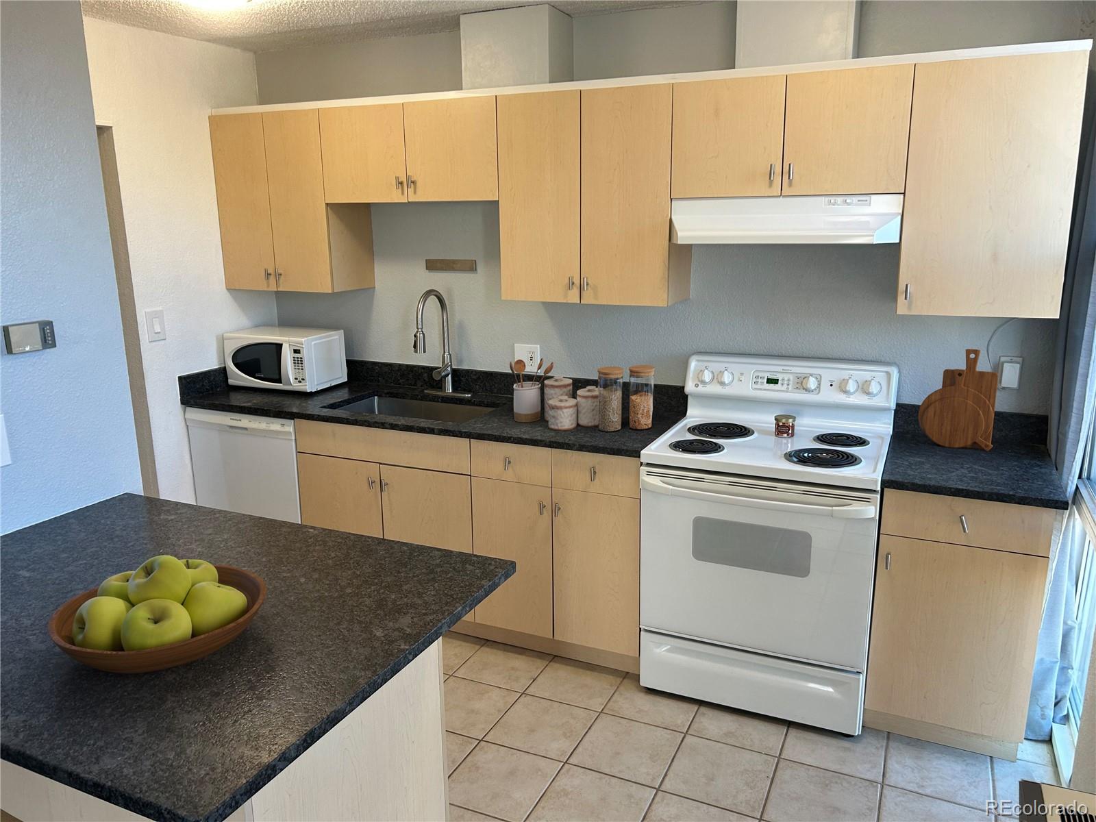 2500 South York Street, Unit 401 Denver, CO 80210 - Photo 4 of 18 a kitchen with a sink appliances and cabinets