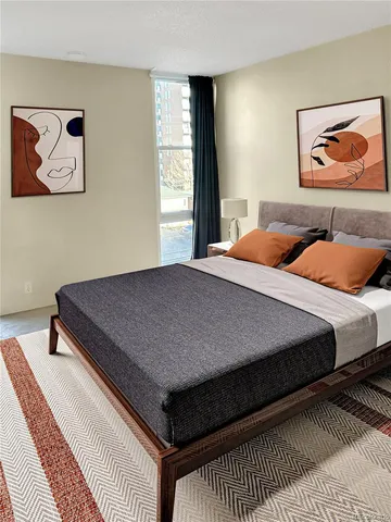 a bedroom with a bed and painting on the wall