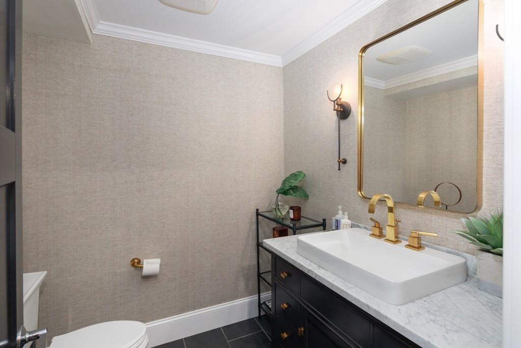 73 Winter Street Hingham, MA 02043 - Photo 19 of 42 a bathroom with a sink a toilet and mirror