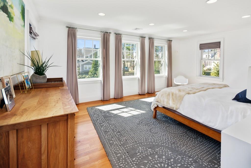 73 Winter Street Hingham, MA 02043 - Photo 22 of 42 a bedroom with a large bed and a potted plant