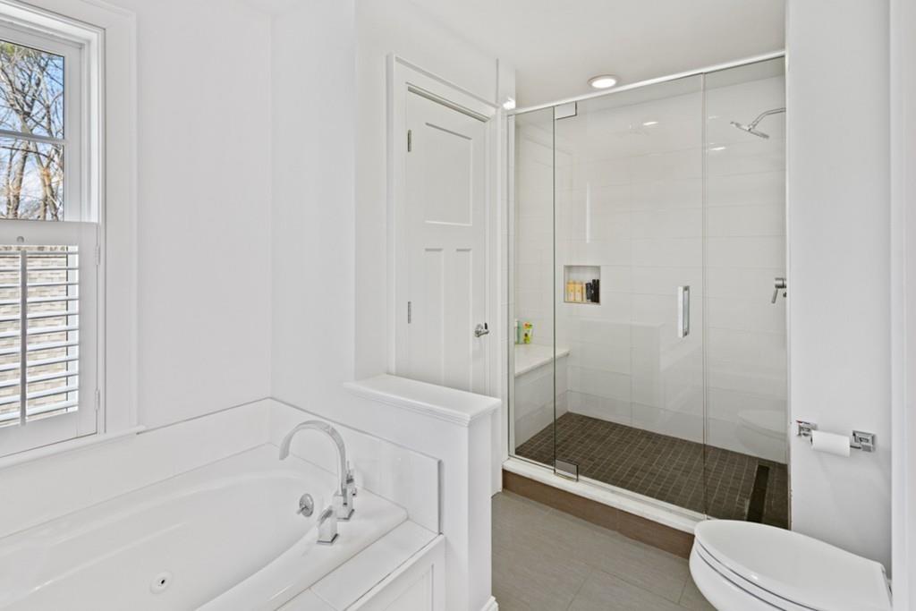 73 Winter Street Hingham, MA 02043 - Photo 25 of 42 a bathroom with a bathtub and a shower
