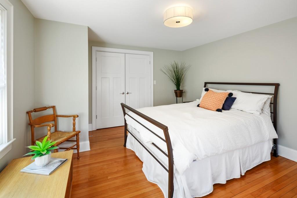 73 Winter Street Hingham, MA 02043 - Photo 27 of 42 a bedroom with a bed and wooden floor