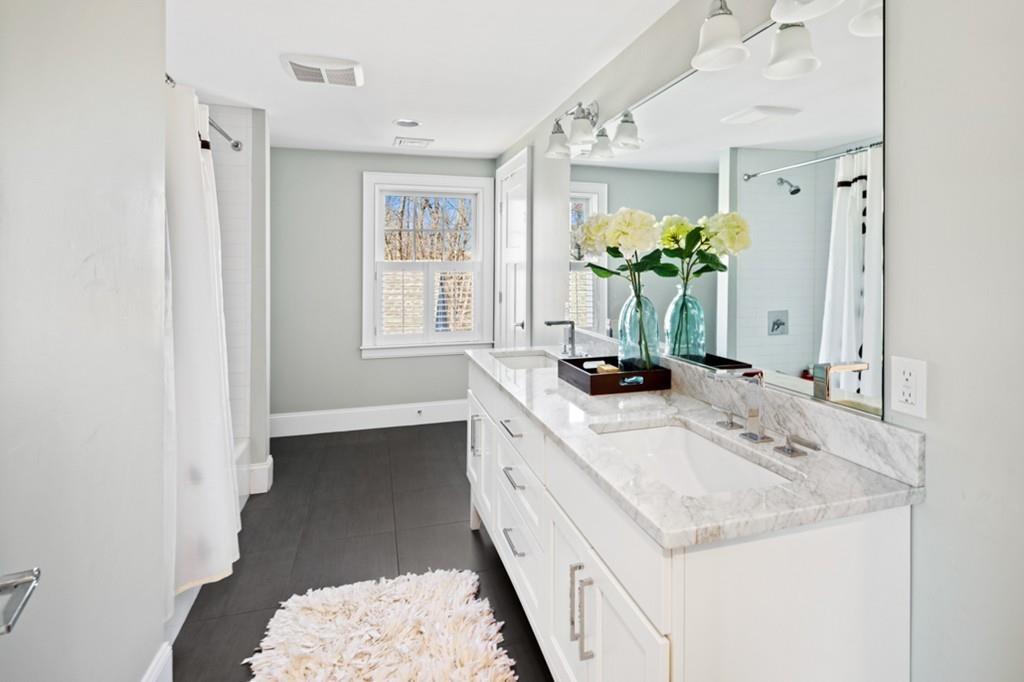 73 Winter Street Hingham, MA 02043 - Photo 30 of 42 a bathroom with a double vanity sink and a mirror