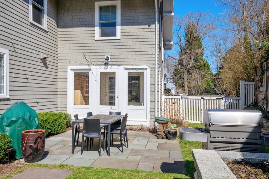 73 Winter Street Hingham, MA 02043 - Photo 36 of 42 a view of a patio with table and chairs potted plants and floor to ceiling window