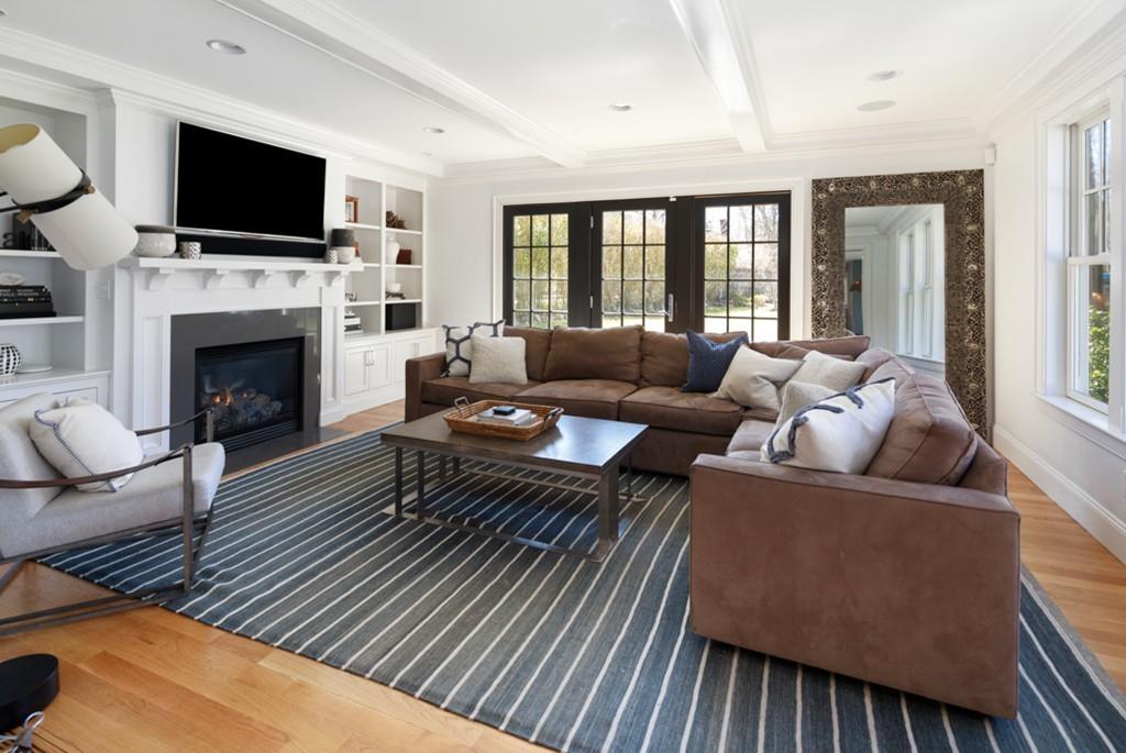 73 Winter Street Hingham, MA 02043 - Photo 8 of 42 a living room with furniture a flat screen tv and a fireplace