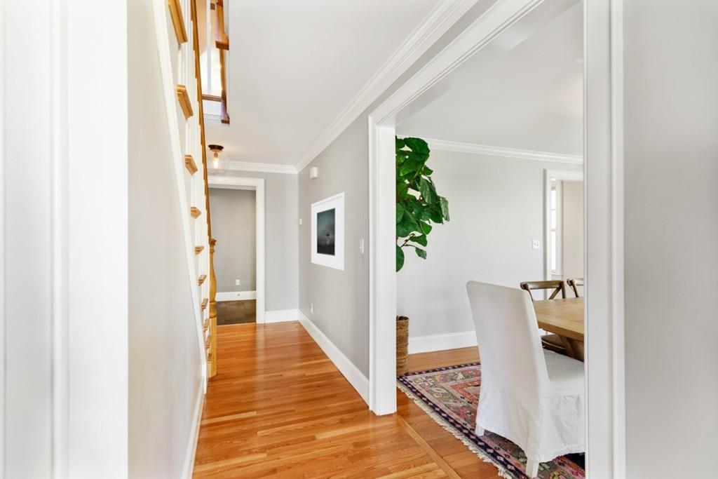 73 Winter Street Hingham, MA 02043 - Photo 9 of 42 a view of a hallway with wooden floor and staircase