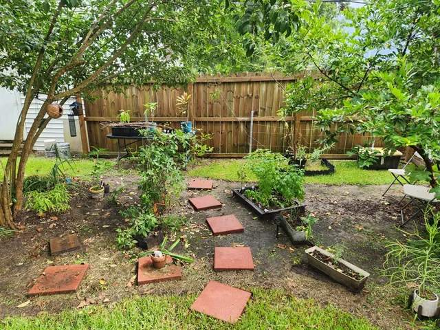 a backyard of a house with a yard and outdoor seating