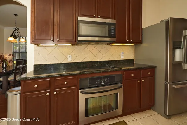 a kitchen with granite countertop cabinets and steel stainless steel appliances