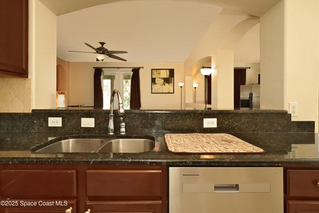 a kitchen with granite countertop a sink and cabinets