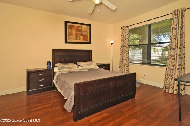 a bedroom with a bed and wooden floor