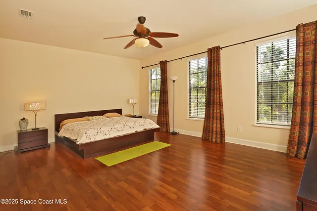a bathroom with a granite countertop sink a mirror and a shower