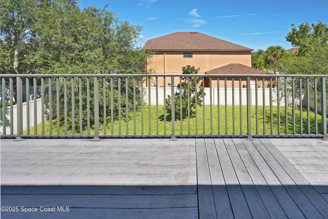 a view of balcony with wooden floor and stairs