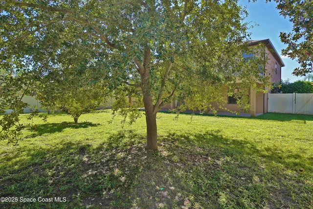 a house is sitting in middle od yard