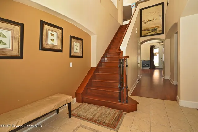 a view of entryway and hall with wooden floor