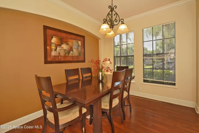 a view of a dining room with furniture wooden floor and chandelier