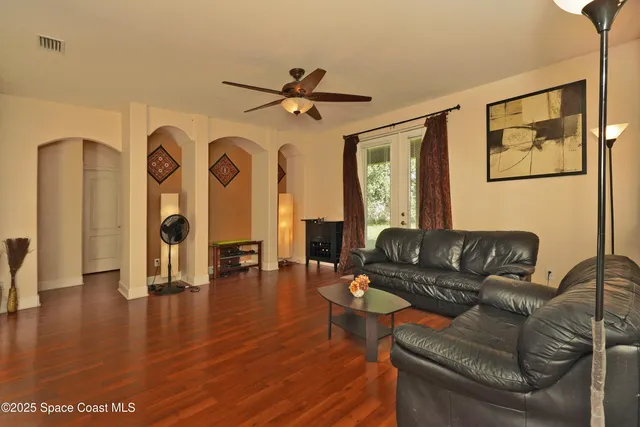 a living room with furniture and wooden floor