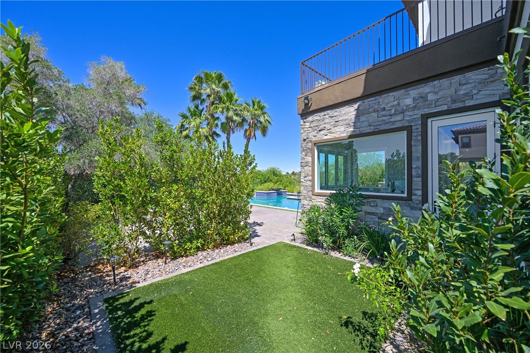 6 Rue Du Ville Henderson, NV 89011 - Photo 74 of 99 This outdoor oasis features a refreshing pool, lush landscaping, and a stylish exterior with natural stone accents.
