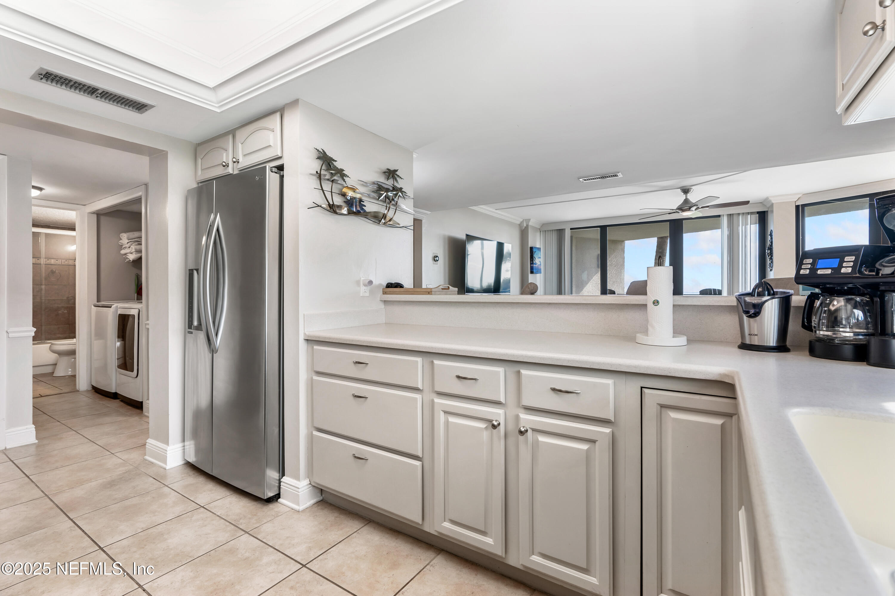2 Dondanville Road, Unit 207 St. Augustine, FL 32080 - Photo 11 of 65 a kitchen with white cabinets and refrigerator