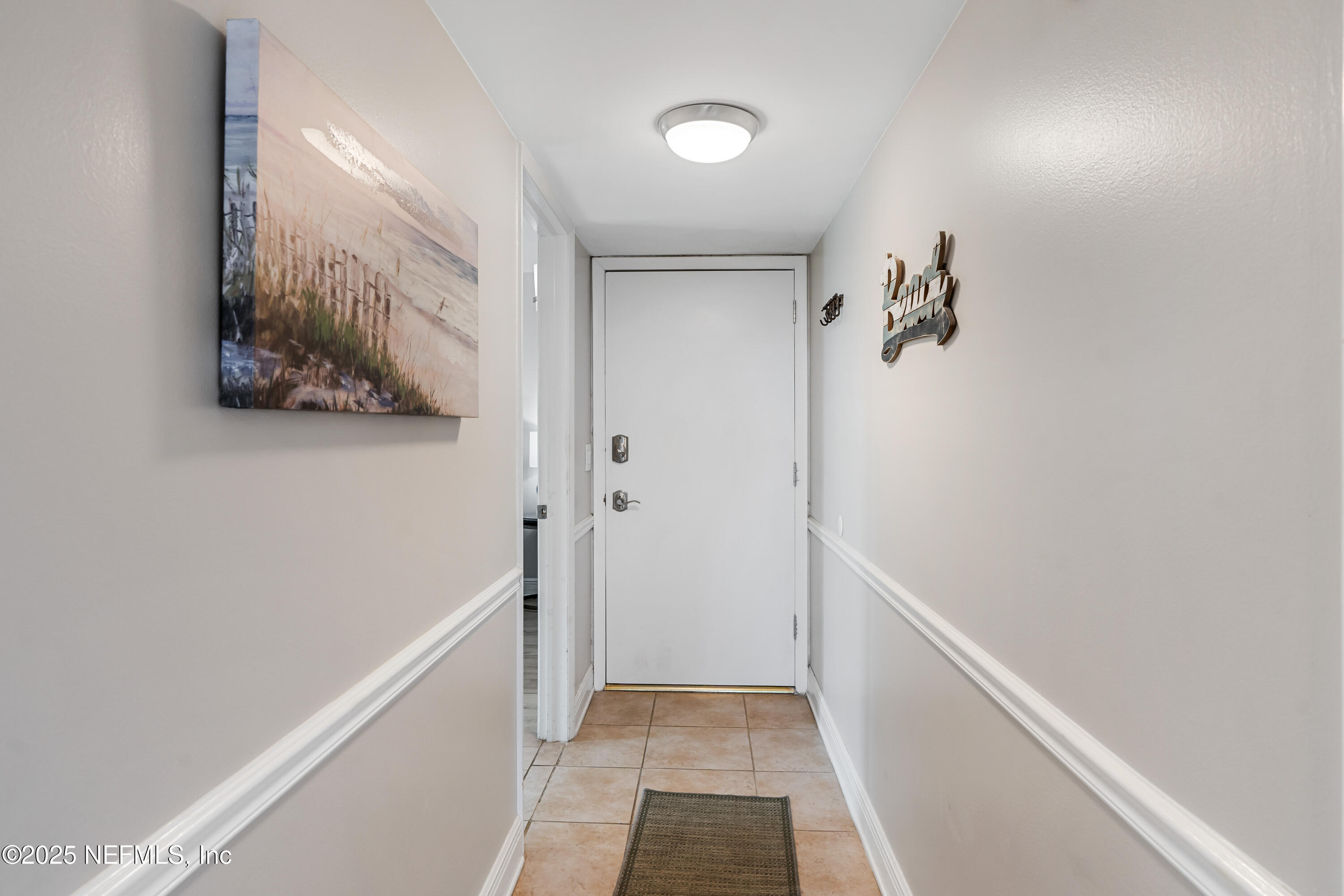 2 Dondanville Road, Unit 207 St. Augustine, FL 32080 - Photo 29 of 65 a view of a hallway with a white walls and a window