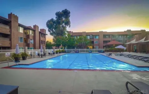 a swimming pool view with a outdoor seating