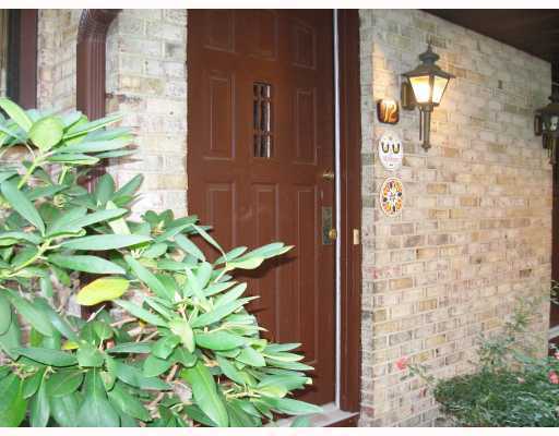 a bathroom with a granite countertop shower and a mirror