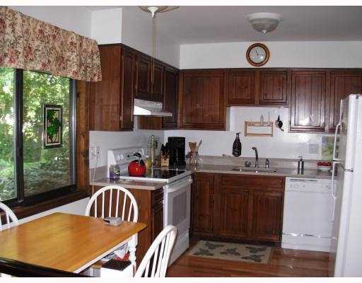 Undisclosed Address Stamford, CT 06905 - Photo 3 of 4 a kitchen with a sink a stove and wooden cabinets