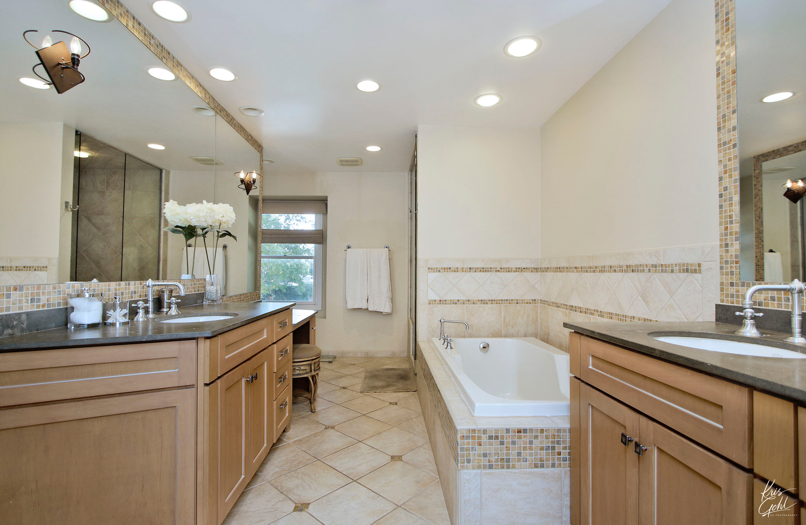 2143 Valley Road Northbrook, IL 60062 - Photo 14 of 26 a bathroom with a sink a large mirror and a bathtub