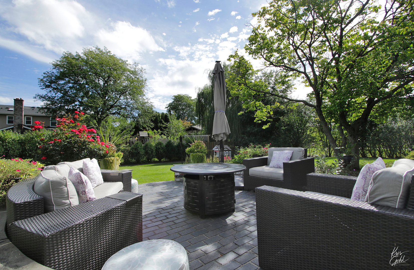 2143 Valley Road Northbrook, IL 60062 - Photo 23 of 26 a view of a patio with couches and a fire pit and a big yard