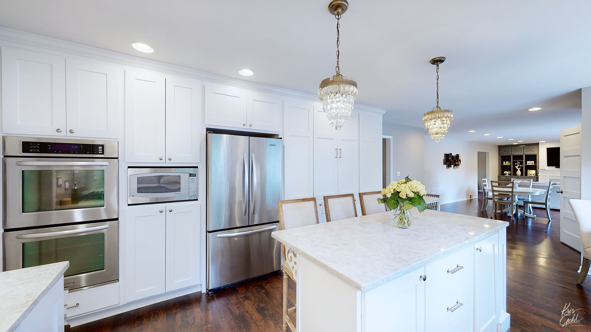 2143 Valley Road Northbrook, IL 60062 - Photo 7 of 26 a kitchen with stainless steel appliances granite countertop a refrigerator a sink dishwasher a oven a dining table and chairs with wooden floor