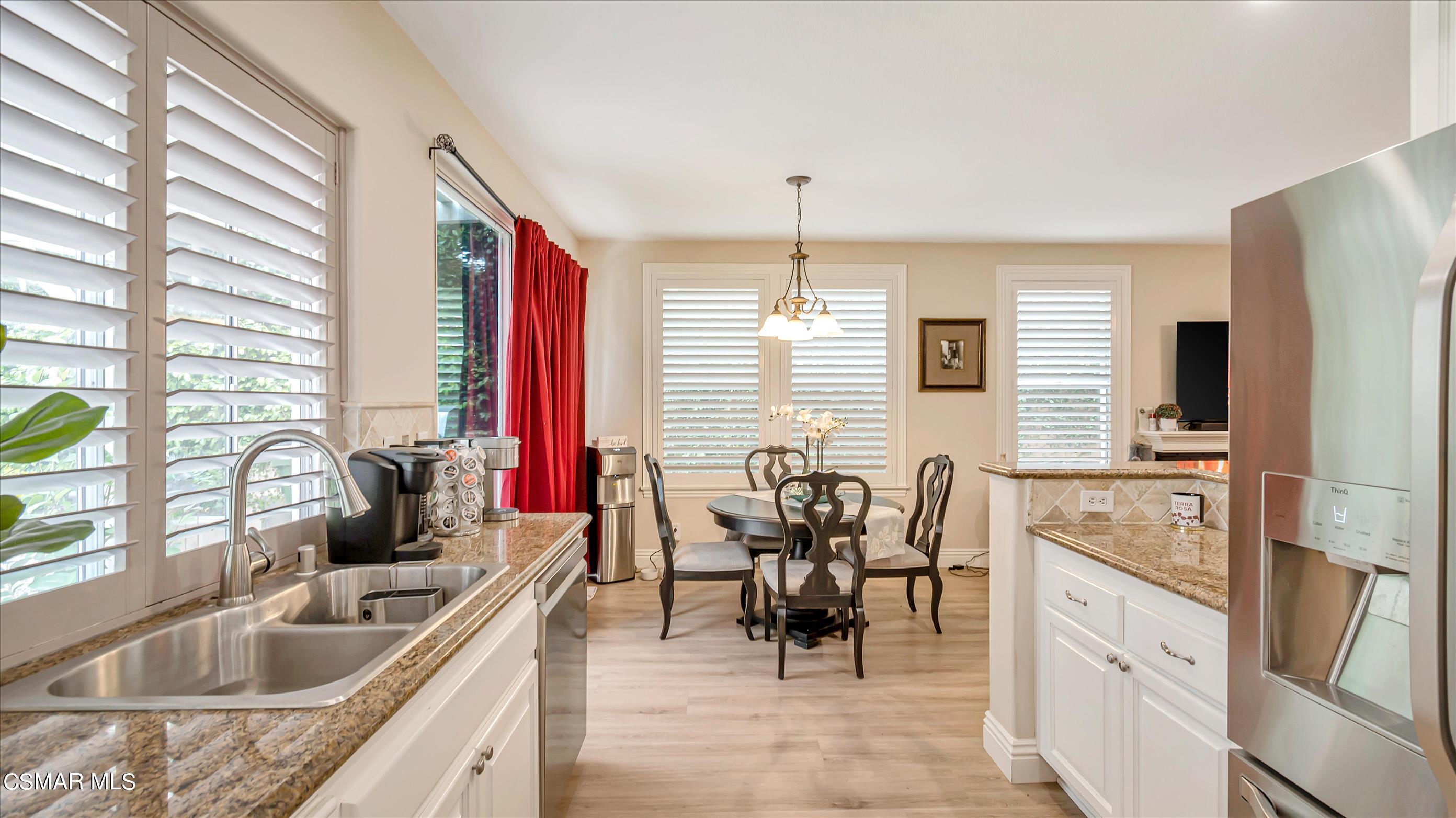 11695 Sagewood Drive Moorpark, CA 93021 - Photo 15 of 31 a kitchen with stainless steel appliances granite countertop sink stove and refrigerator