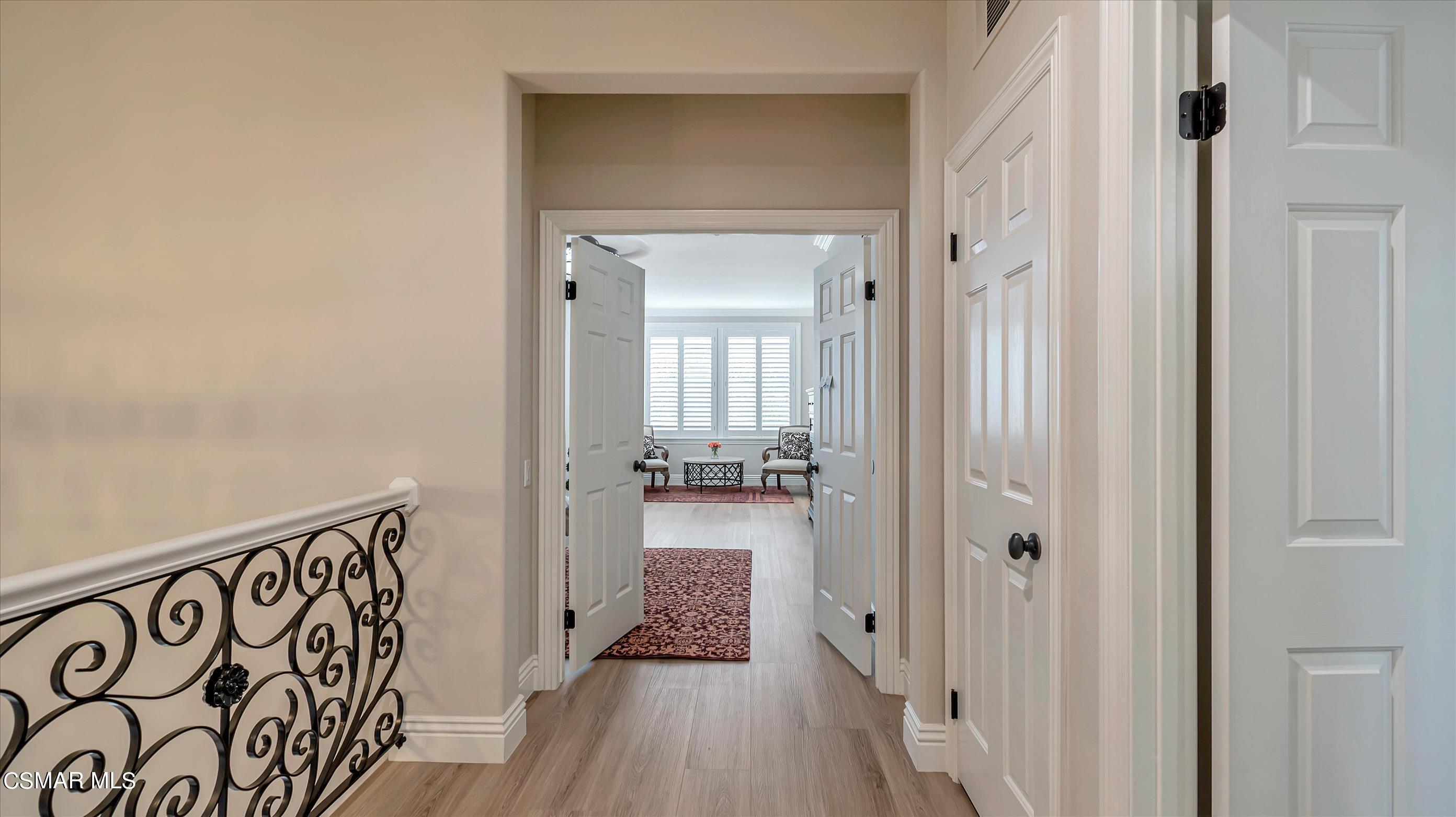 11695 Sagewood Drive Moorpark, CA 93021 - Photo 20 of 31 a view of a hallway with wooden floor and a bathroom