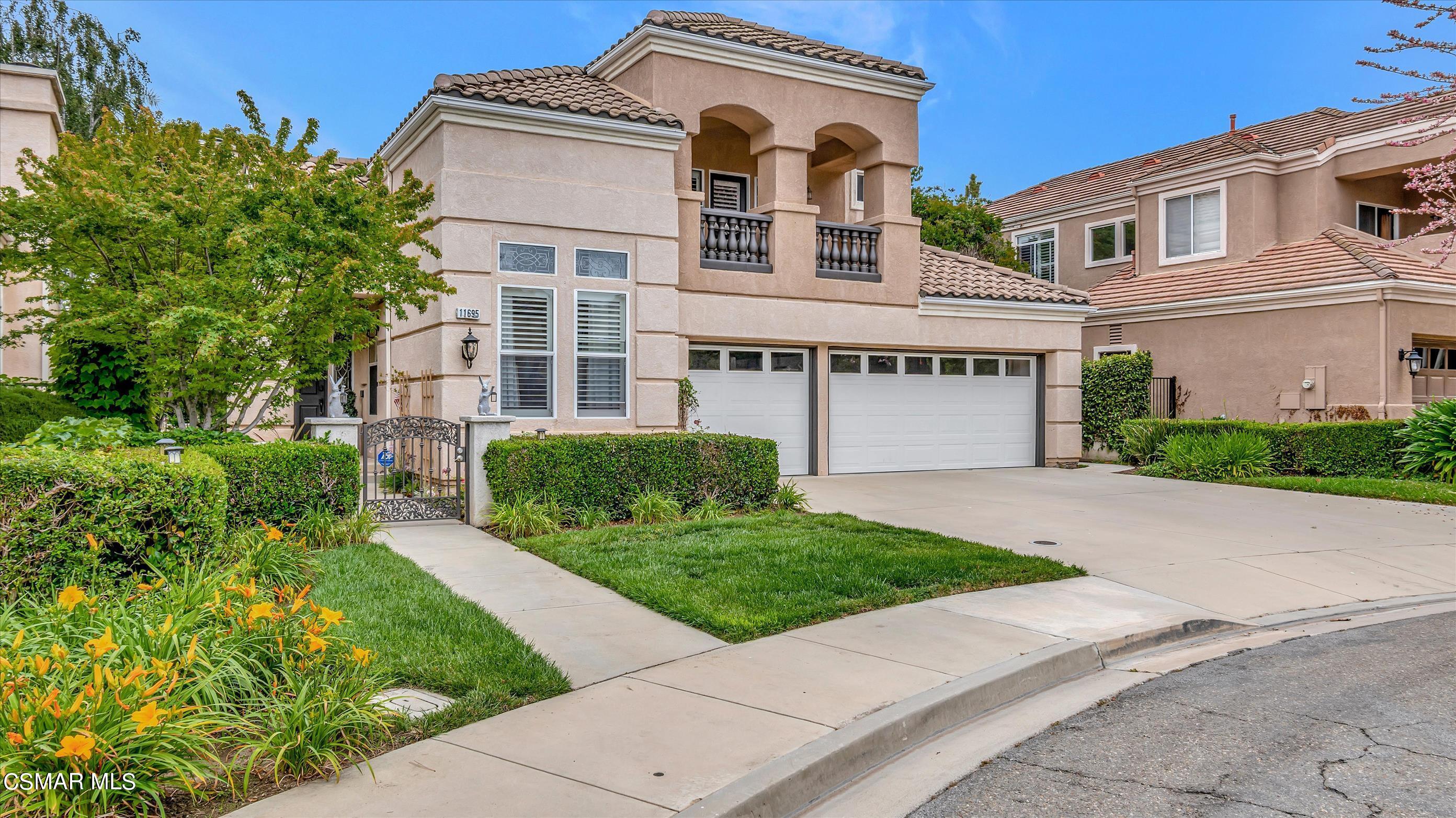 11695 Sagewood Drive Moorpark, CA 93021 - Photo 2 of 31 front view of a house with a yard