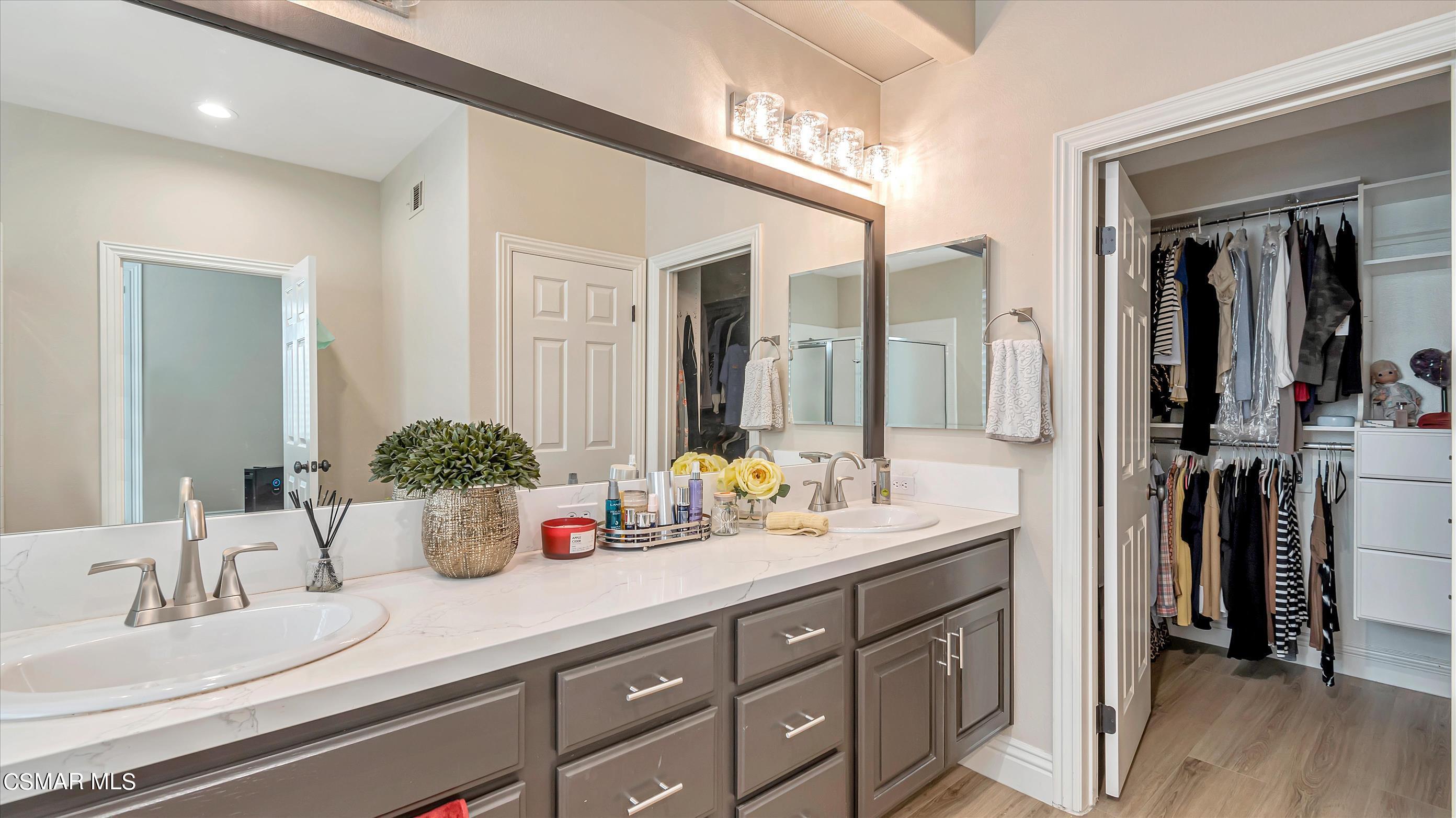 11695 Sagewood Drive Moorpark, CA 93021 - Photo 23 of 31 a bathroom with a double vanity sink and a mirror