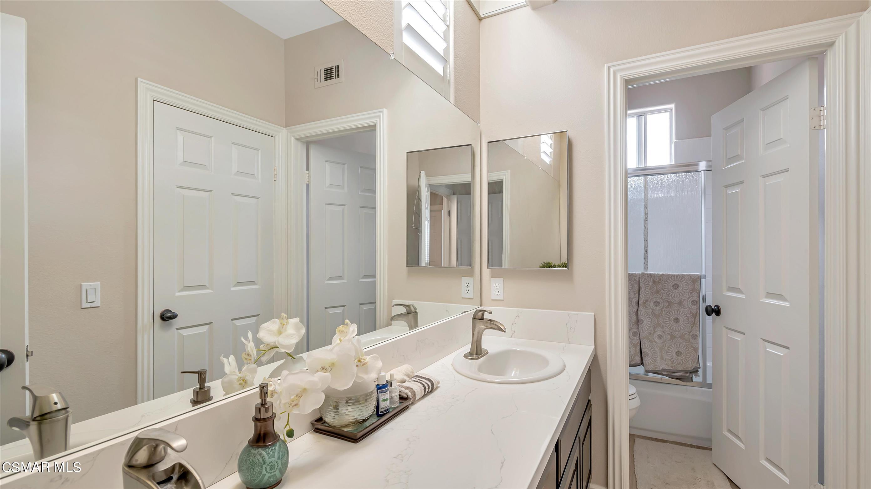 11695 Sagewood Drive Moorpark, CA 93021 - Photo 27 of 31 a en suite bathroom with a double vanity sink and a mirror