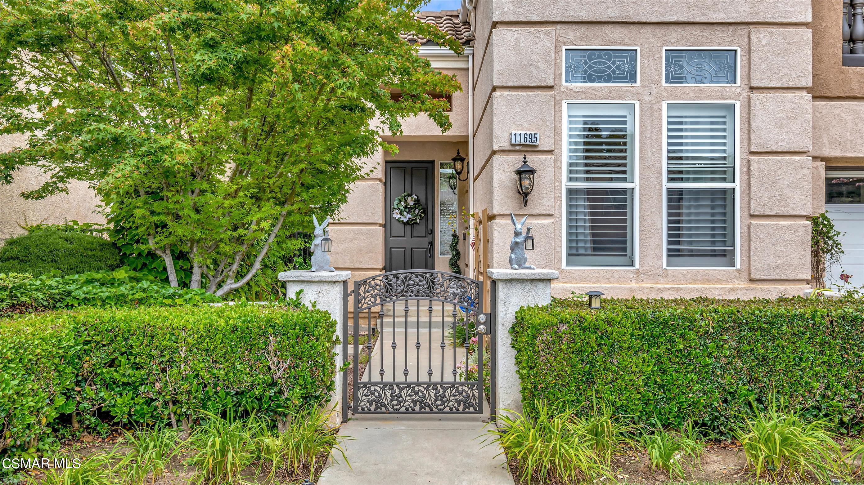 11695 Sagewood Drive Moorpark, CA 93021 - Photo 3 of 31 front view of a house with a garden