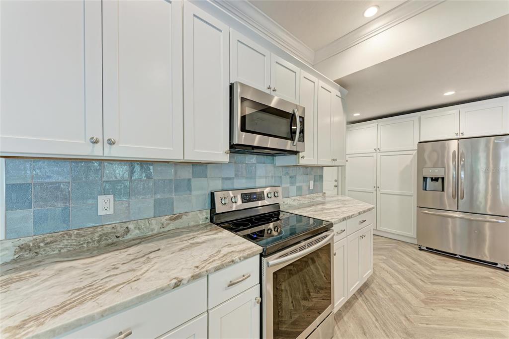 51 Webb Street Osprey, FL 34229 - Photo 16 of 56 a kitchen with stainless steel appliances granite countertop a stove a microwave and a refrigerator