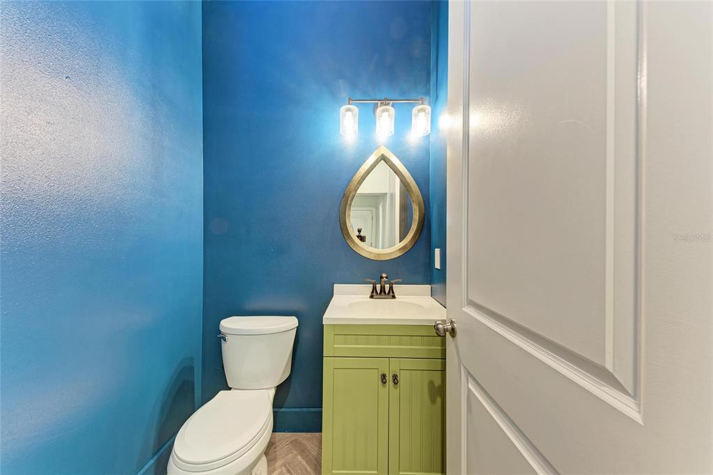 51 Webb Street Osprey, FL 34229 - Photo 35 of 56 a bathroom with a toilet sink vanity and mirror