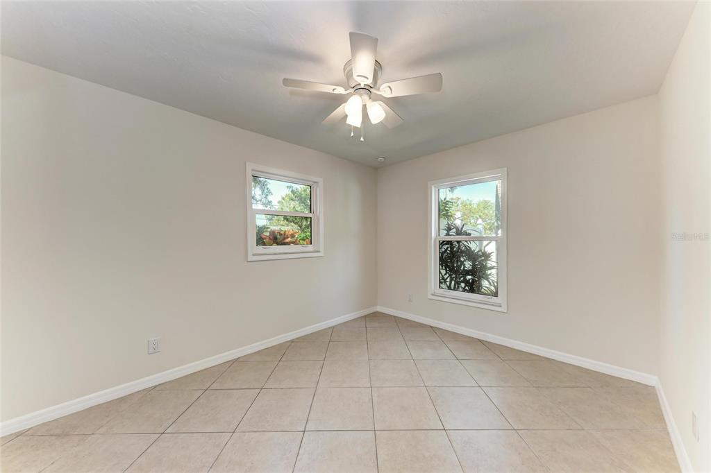 51 Webb Street Osprey, FL 34229 - Photo 36 of 56 an empty room with windows and fan