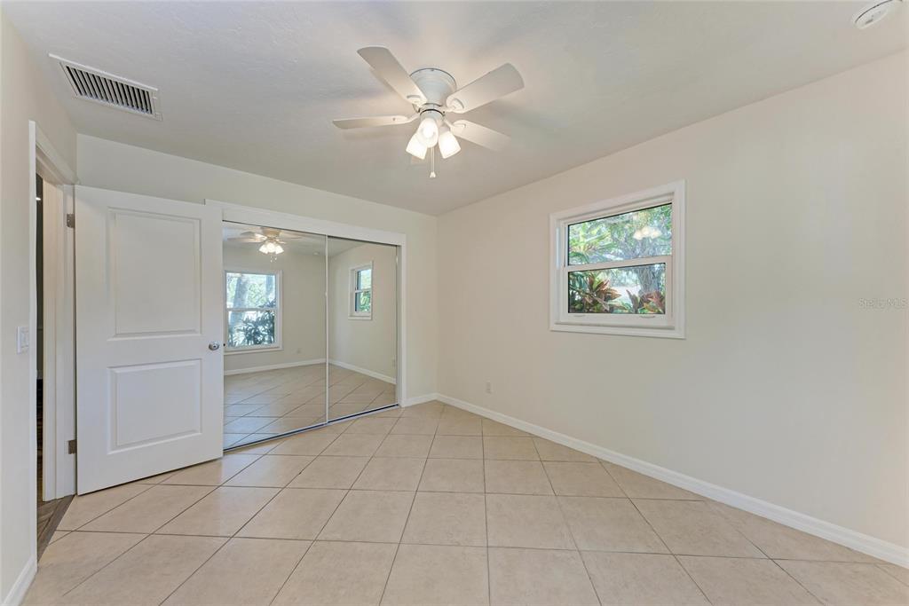 51 Webb Street Osprey, FL 34229 - Photo 37 of 56 a view of an empty room with window and chandelier fan