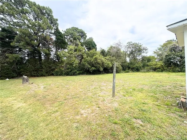 a view of yard with swimming pool and trees
