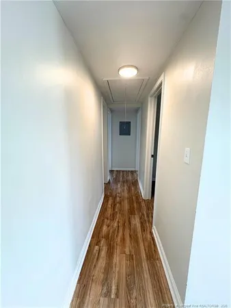 a view of a hallway with wooden floor