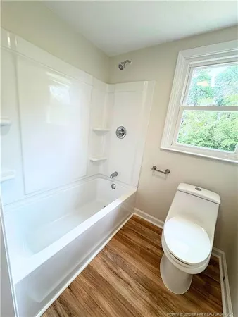 a bathroom with a toilet and a bathtub