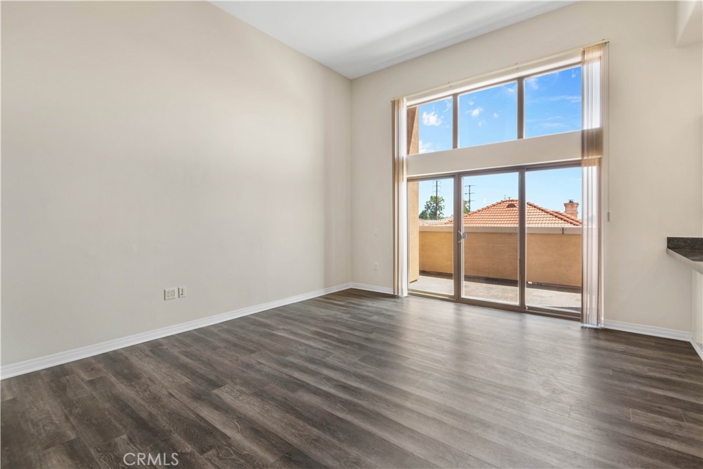 600 North Atlantic Boulevard, Unit 213 Monterey Park, CA 91754 - Photo 3 of 28 a view of an empty room with wooden floor and a window