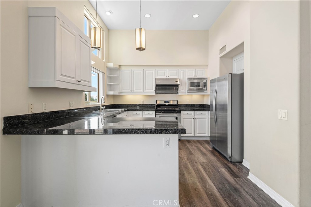 600 North Atlantic Boulevard, Unit 213 Monterey Park, CA 91754 - Photo 5 of 28 a kitchen with stainless steel appliances granite countertop a refrigerator a stove and a sink