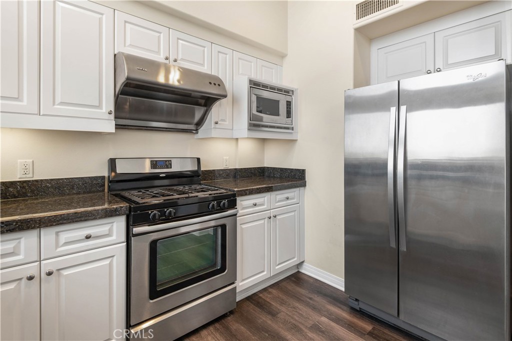 600 North Atlantic Boulevard, Unit 213 Monterey Park, CA 91754 - Photo 6 of 28 a kitchen with stainless steel appliances granite countertop a stove a refrigerator and a microwave