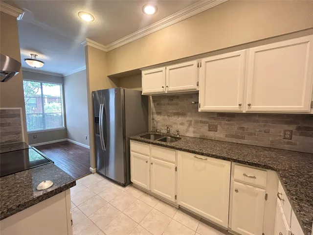 a close view of a sink in a granite counter top