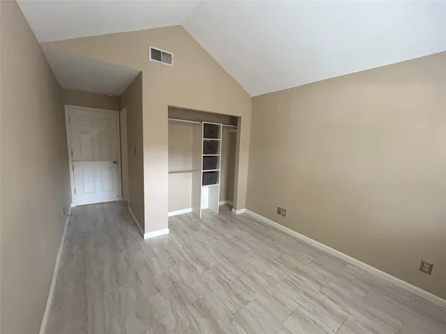 a bathroom with a granite countertop toilet sink and mirror