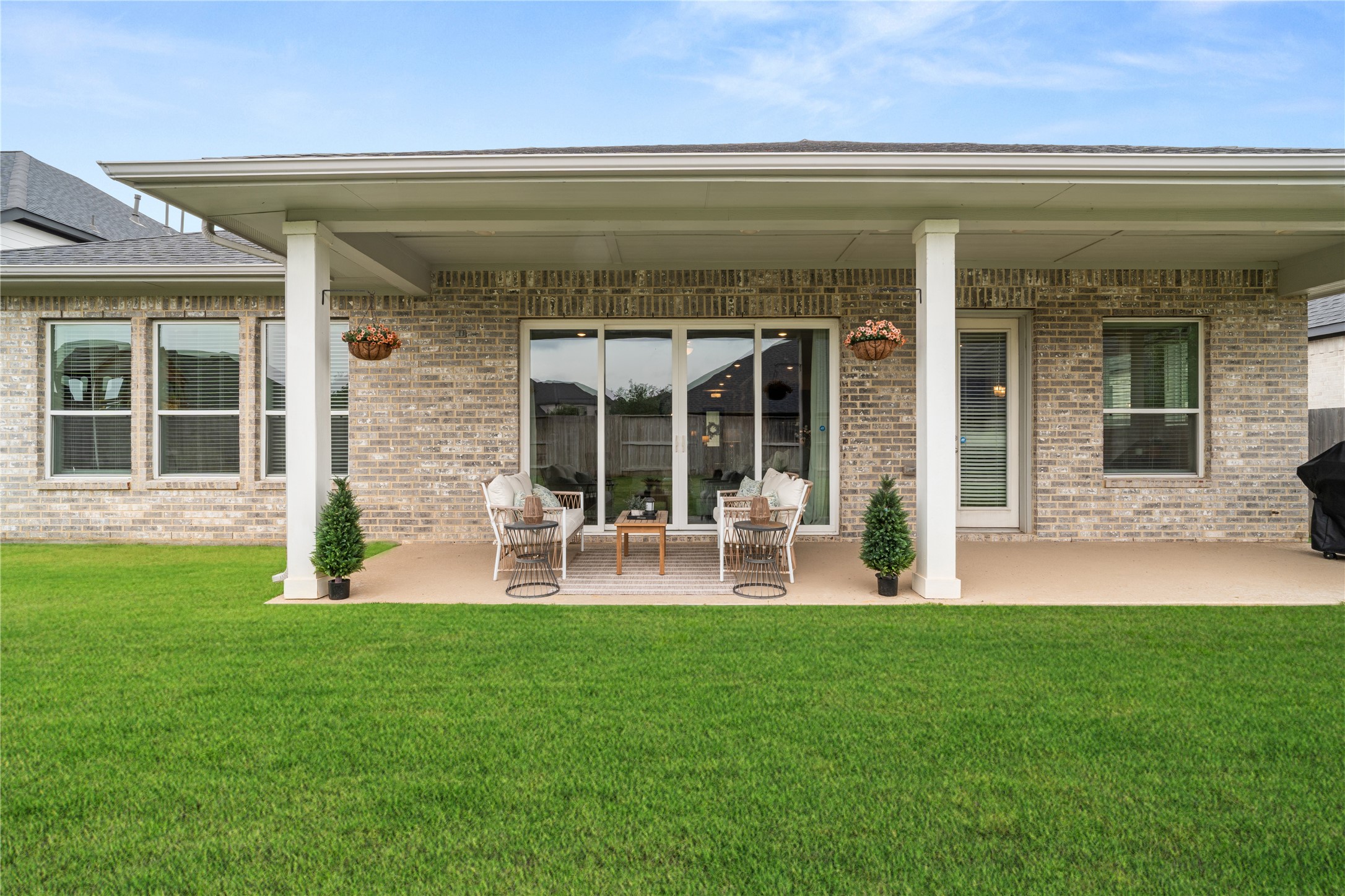 3118 Swift Way Katy, TX 77493 - Photo 33 of 34 Rear Exterior – Rear elevation showcases covered patio, multiple windows, and a functional outdoor living space.